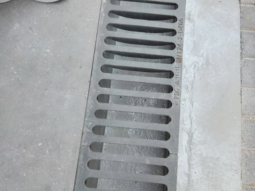 Ductile iron channel drainage grating installed in a paved run, cast EN 124-2 D400