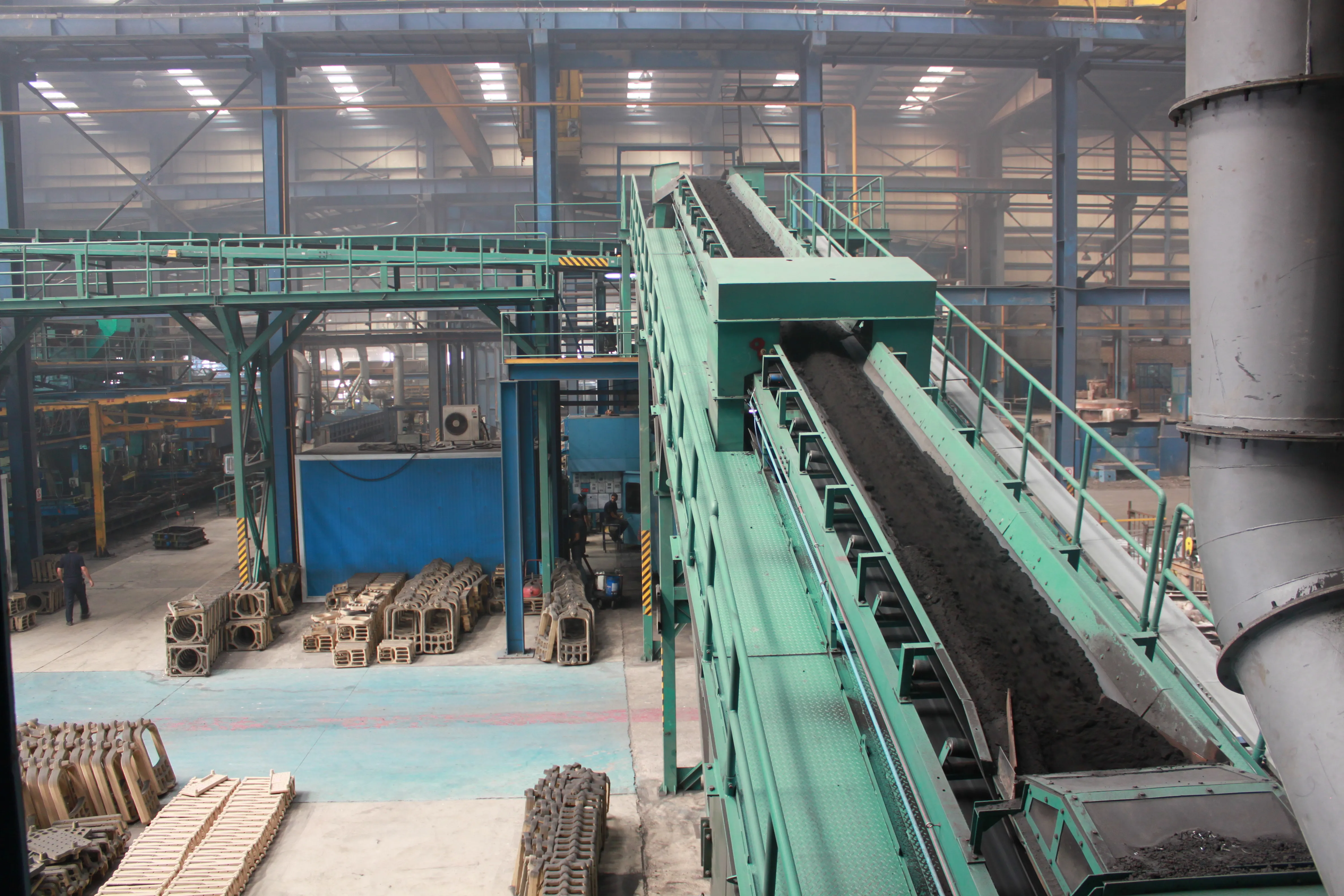 Foundry hall with conveyor and stacked ductile iron castings